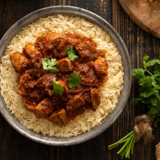 Chicken Vindaloo is a fiery and tangy dish from Goan cuisine, heavily influenced by Portuguese flavors. It's known for its spicy and slightly vinegary taste, made with a blend of aromatic spices and marinated chicken.