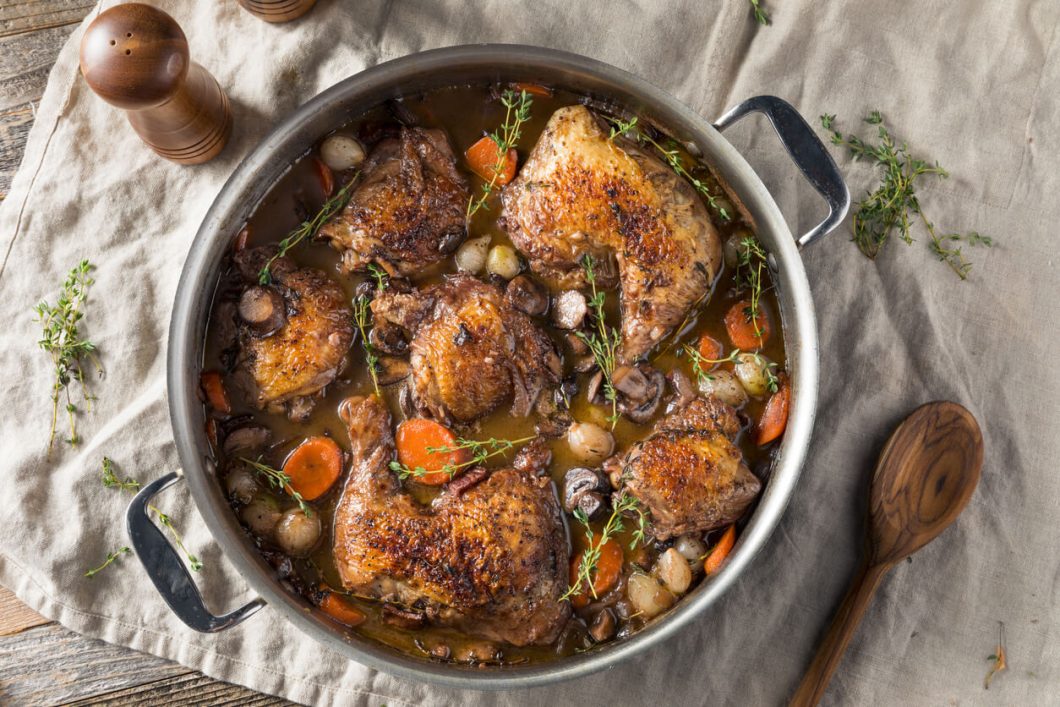 Coq au Vin is a classic French dish that translates to "rooster in wine." It's a hearty stew where chicken is slowly braised with wine, mushrooms, onions, and bacon, creating a rich and flavorful meal.