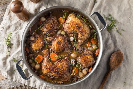 Coq au Vin is a classic French dish that translates to "rooster in wine." It's a hearty stew where chicken is slowly braised with wine, mushrooms, onions, and bacon, creating a rich and flavorful meal.