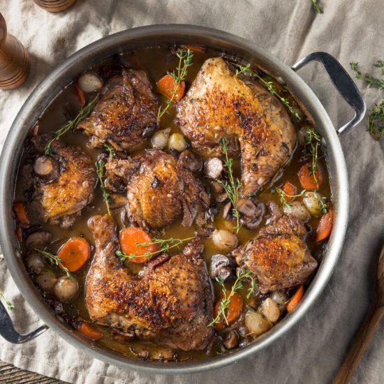 Coq au Vin is a classic French dish that translates to "rooster in wine." It's a hearty stew where chicken is slowly braised with wine, mushrooms, onions, and bacon, creating a rich and flavorful meal.