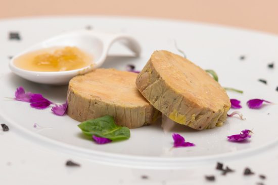 Foie Gras au Torchon is a luxurious French delicacy where foie gras is marinated, rolled in a cloth (torchon means 'kitchen towel' in French), and then poached to perfection.