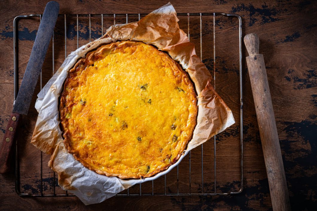 Quiche Lorraine is a classic French dish that features a savory custard made with eggs, cream, and bacon, poured into a buttery pastry crust.