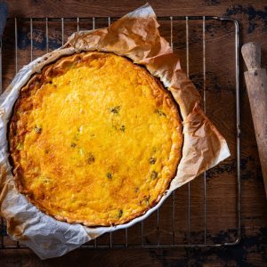 Quiche Lorraine is a classic French dish that features a savory custard made with eggs, cream, and bacon, poured into a buttery pastry crust.