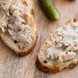 Rillettes du Mans is a classic French spread made from slow-cooked, seasoned pork that is shredded and stored in its own fat.