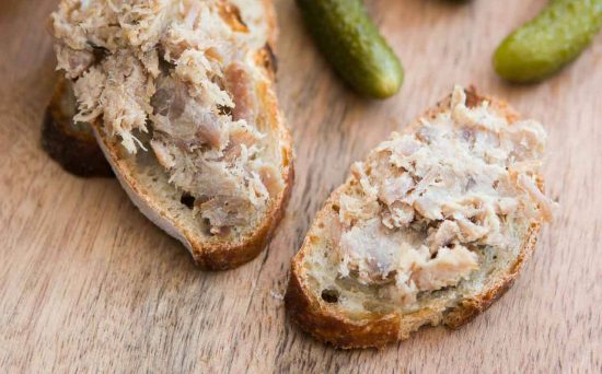 Rillettes du Mans is a classic French spread made from slow-cooked, seasoned pork that is shredded and stored in its own fat.