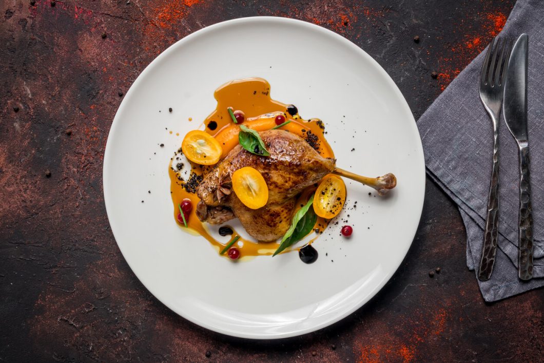 Confit de Canard is a celebrated French dish where duck legs are slowly cooked in their own fat, resulting in tender, flavorful meat with a crisp, golden skin.