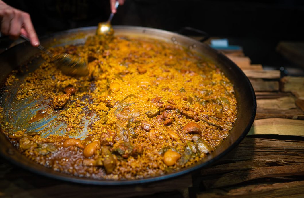 Paella Valenciana is a festive dish perfect for gatherings and special occasions, embodying the essence of Spanish culinary tradition with its elaborate preparation and robust flavors.