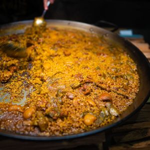 Paella Valenciana is a festive dish perfect for gatherings and special occasions, embodying the essence of Spanish culinary tradition with its elaborate preparation and robust flavors.