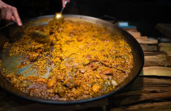 Paella Valenciana is a festive dish perfect for gatherings and special occasions, embodying the essence of Spanish culinary tradition with its elaborate preparation and robust flavors.